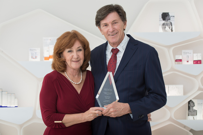 Val Carstens and Dr Des Fernandes holding an award